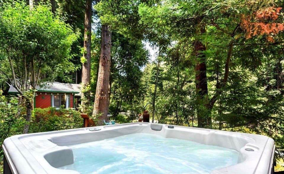 An amazing hot tub set up on a deck to overlook the creek