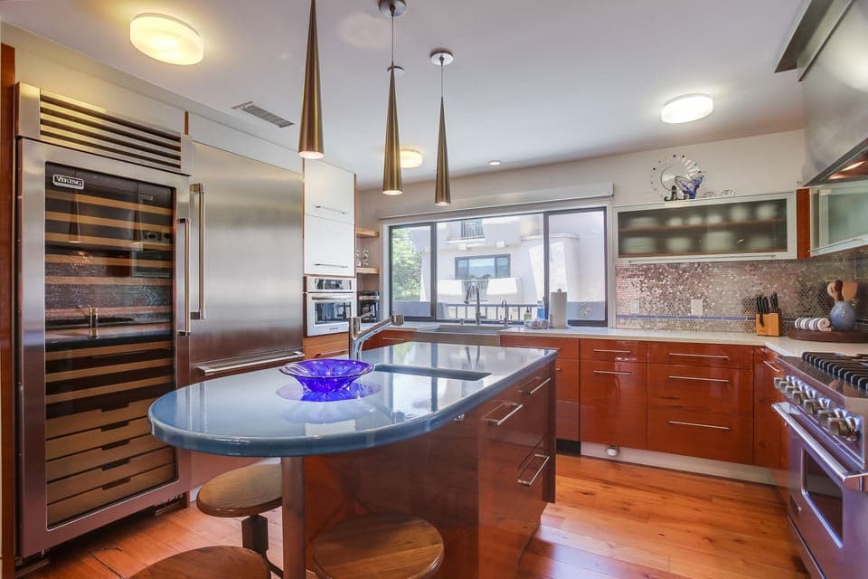 Seating for three at the ocean colored kitchen bar.