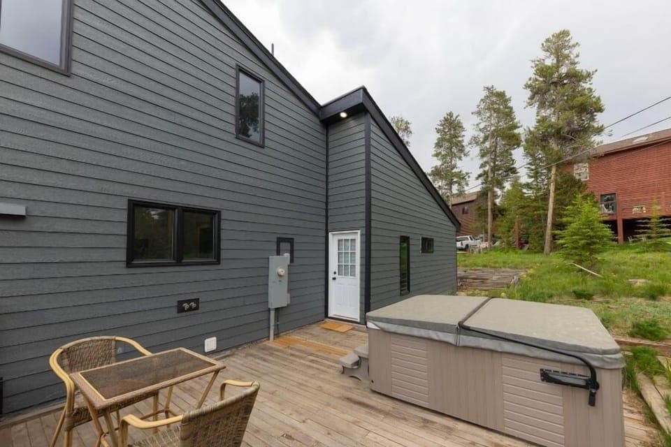 Spacious back deck with outdoor seating and access to the private hot tub.