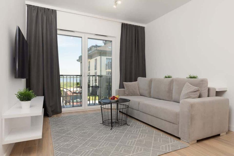 Relax in the stylish living room with a comfortable sofa and modern decor.