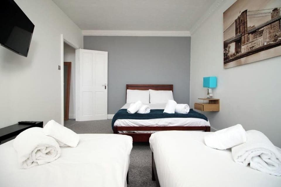 Step into our charming apartment, where comfort meets character. The bedroom is designed with a warm, cozy vibe featuring a comfortable bed with soft linens, fluffy pillows, and warm lighting that creates the perfect space to relax and unwind.