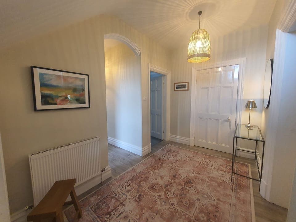 The front door opens into a spacious and elegant hallway