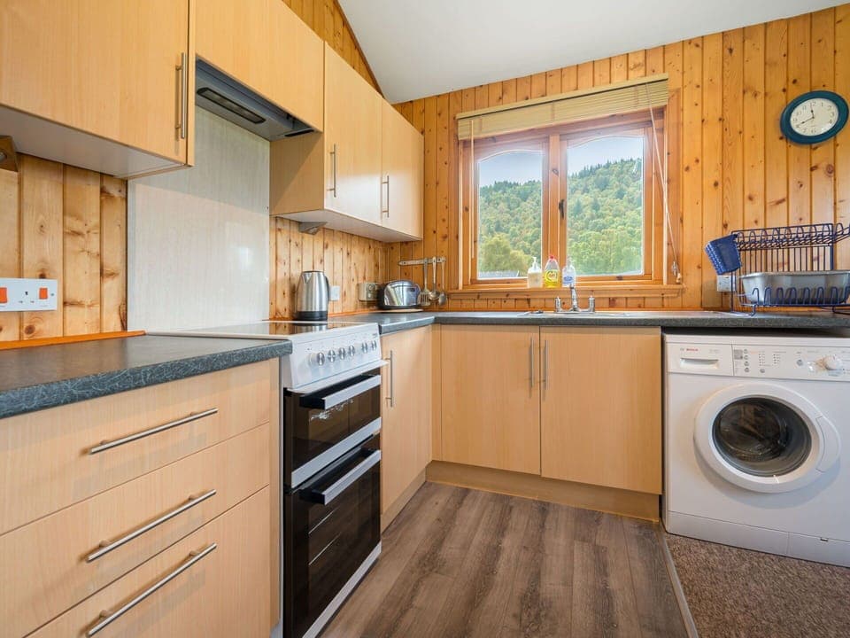 Laundry Room, Cabinetry, Countertop, Property, Kitchen, Kitchen Appliance, Kitchen Stove, Wood, Window, Home Appliance