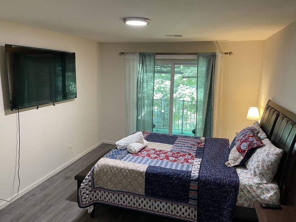 Queen bed with memory foam mattress and 65” smart tv 