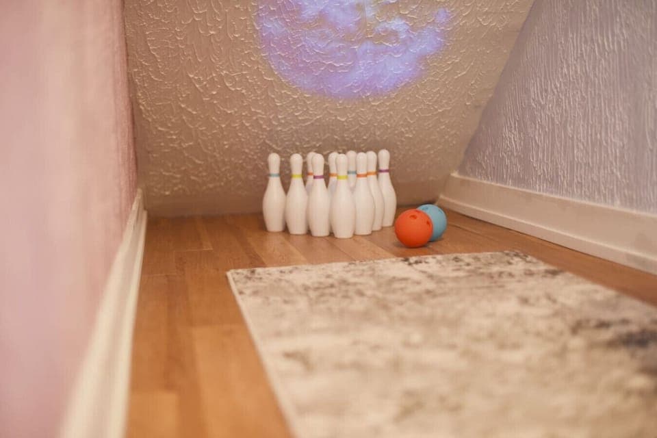 Under the stairway bowling alley in the *KIDS ONLY* Room. A small projector and several puzzles are provided for leisure.