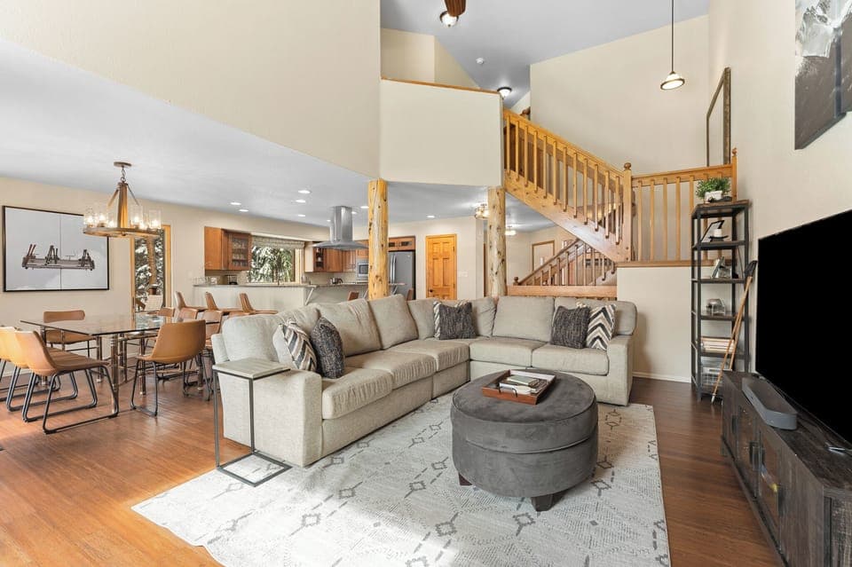 Living area features cozy furnishings, a gas fireplace, ceiling fan, and SmartTV.