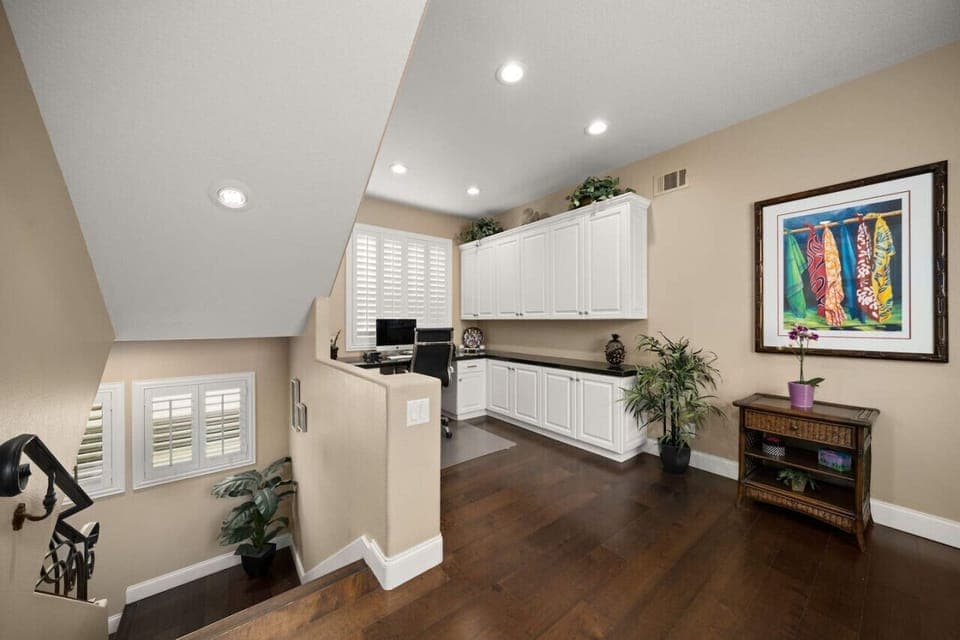 The second-floor features wood floors with Office desk and chair with plenty of space and printer.