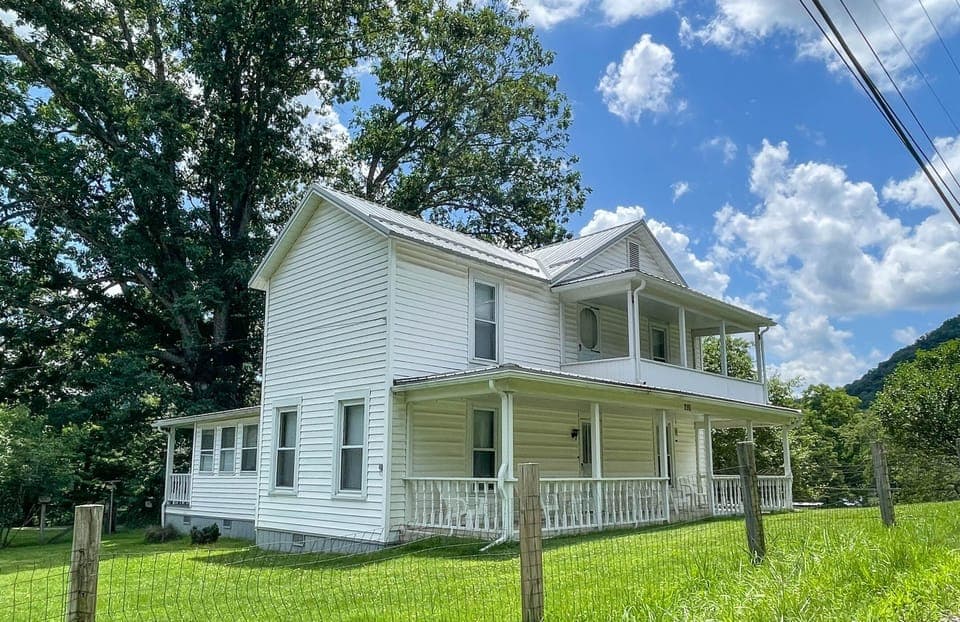 A beautiful two-story home rooted in the town's lumber-era history, set among classic company houses yet standing apart with its larger footprint and finer details—suggesting it was built for someone of higher standing.
