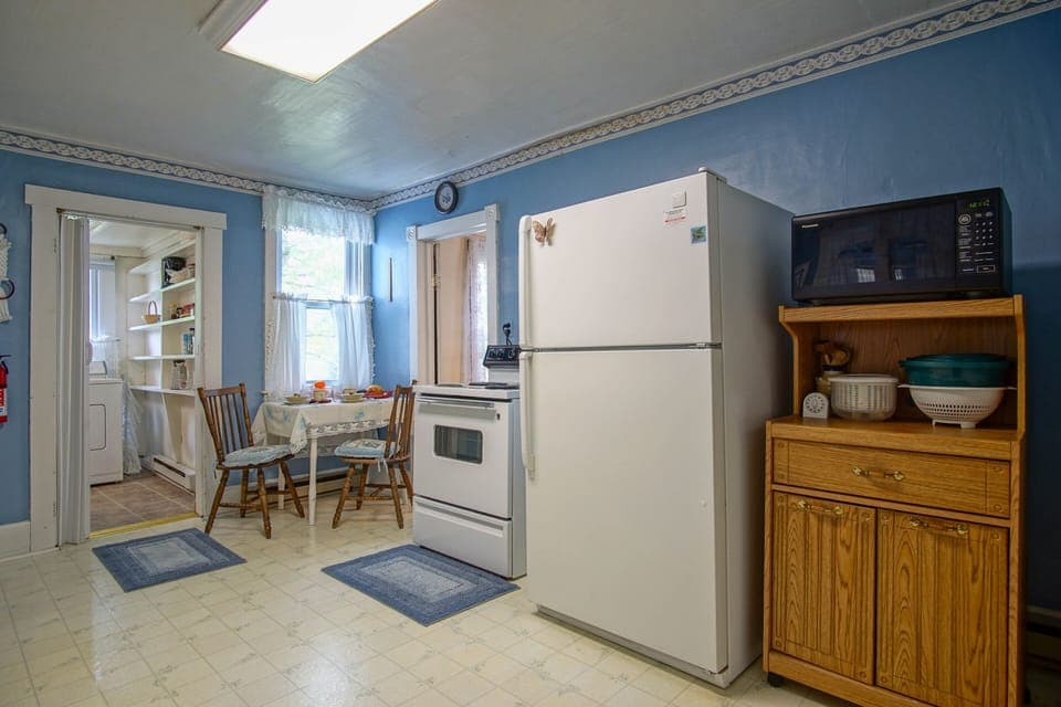 Charming vintage kitchen with classic character—cozy and functional, with limited counter space and a modest number of outlets, typical of homes from this era.
