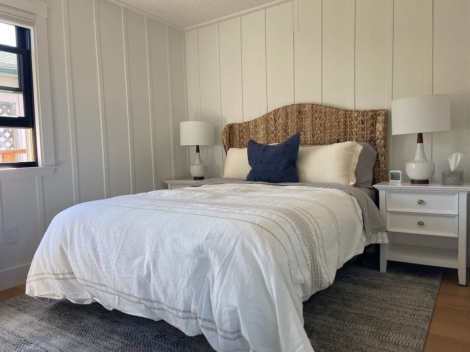 Bedroom has queen bed and door to small side deck.