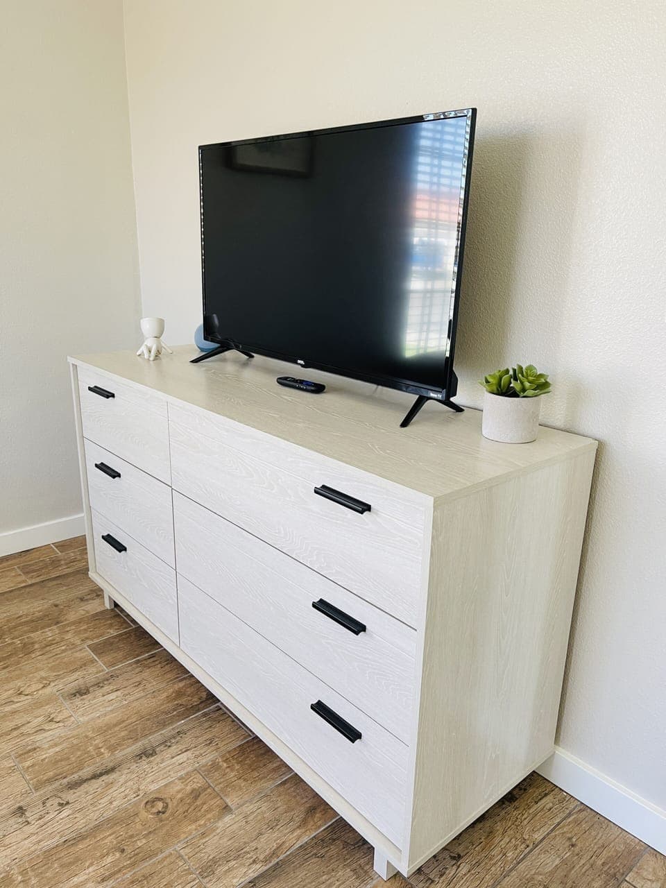 Twin bedroom tv and dresser