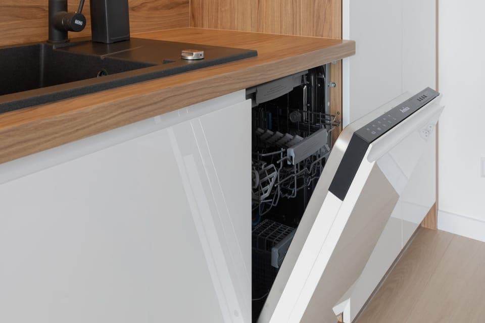 Close-up of the kitchenette with white cabinets and quality appliances that allow you to prepare home-cooked meals.