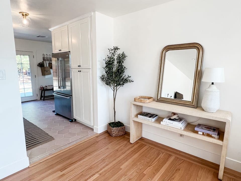 The entryway with fashionable coffee table books flows into the kitchen. 