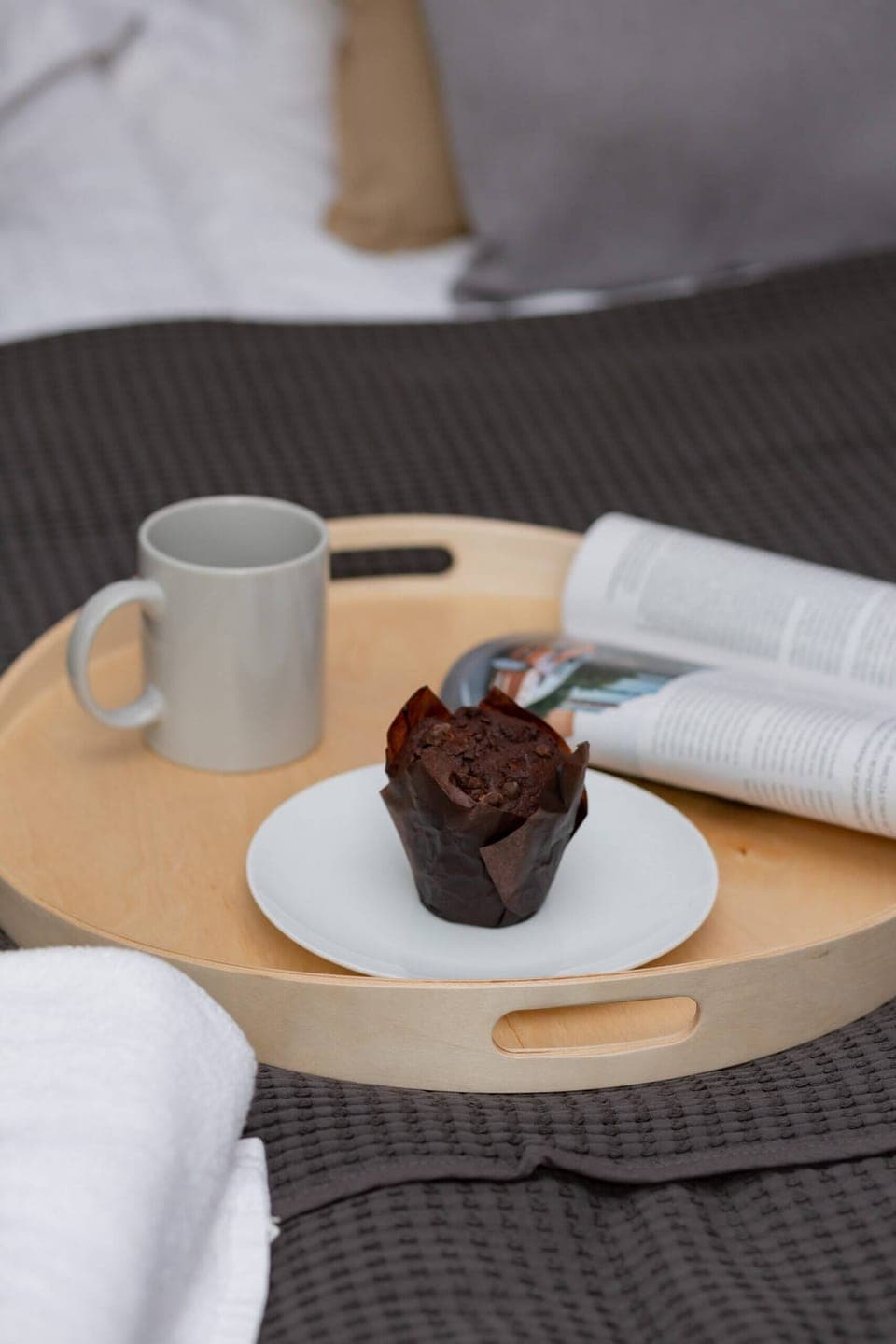 A small table with a cup of coffee and dessert is set up, giving a cozy morning vibe.