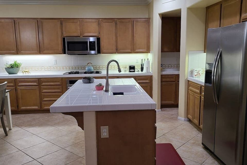 Open Kitchen with Island and Stainless steel Appliances. 