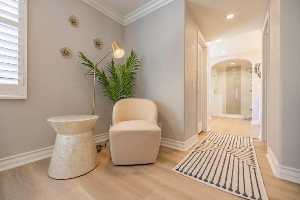 Cozy hallway nook with accent chair and calming design touches.