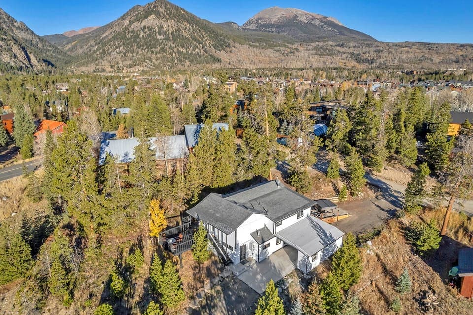 Nature's Embrace: Surrounded by magnificent trees and within walking distance to Main St and surrounding hiking trails, this home is a sanctuary for nature lovers. 