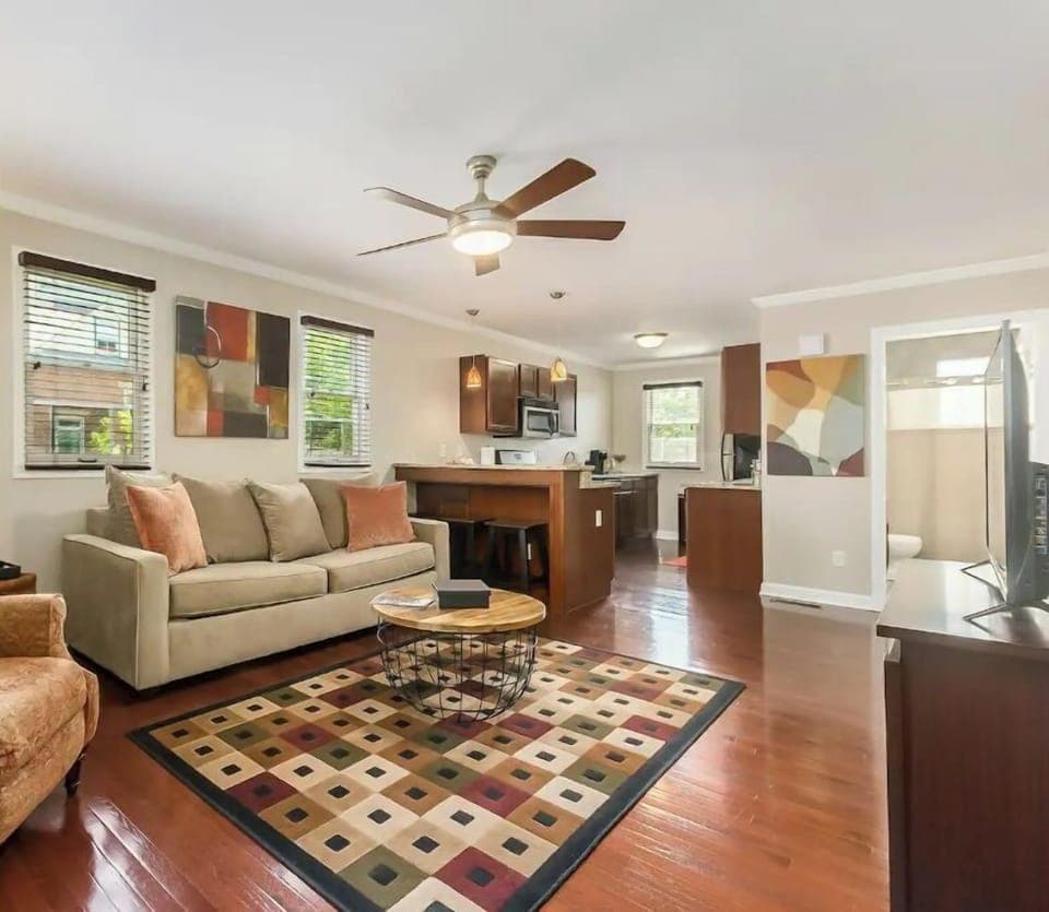 Living room includes a cozy sleeper sofa, reclining chair, and smart tv. 