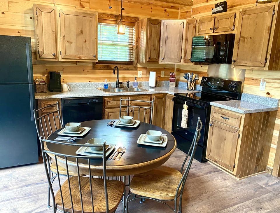 This cabin features features a fully stocked kitchen and dining area.