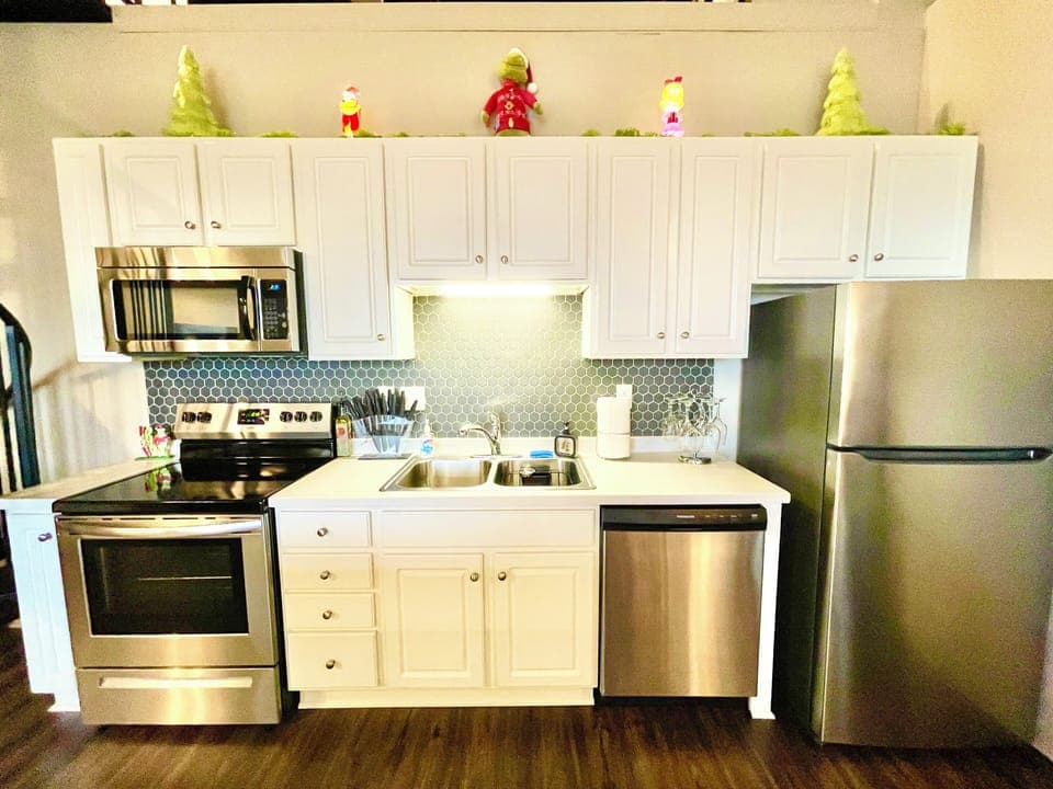 Cook up some Christmas cheer in this modern kitchen with stainless-steel appliances and whimsical Grinch décor touches.