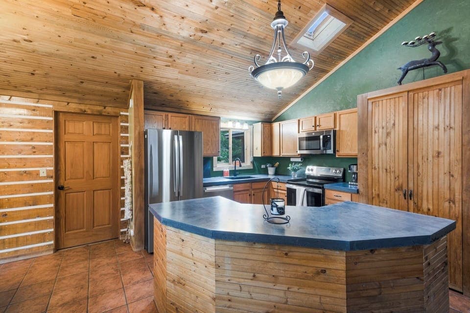 Fully equipped kitchen stainless steel appliances and concrete countertops.