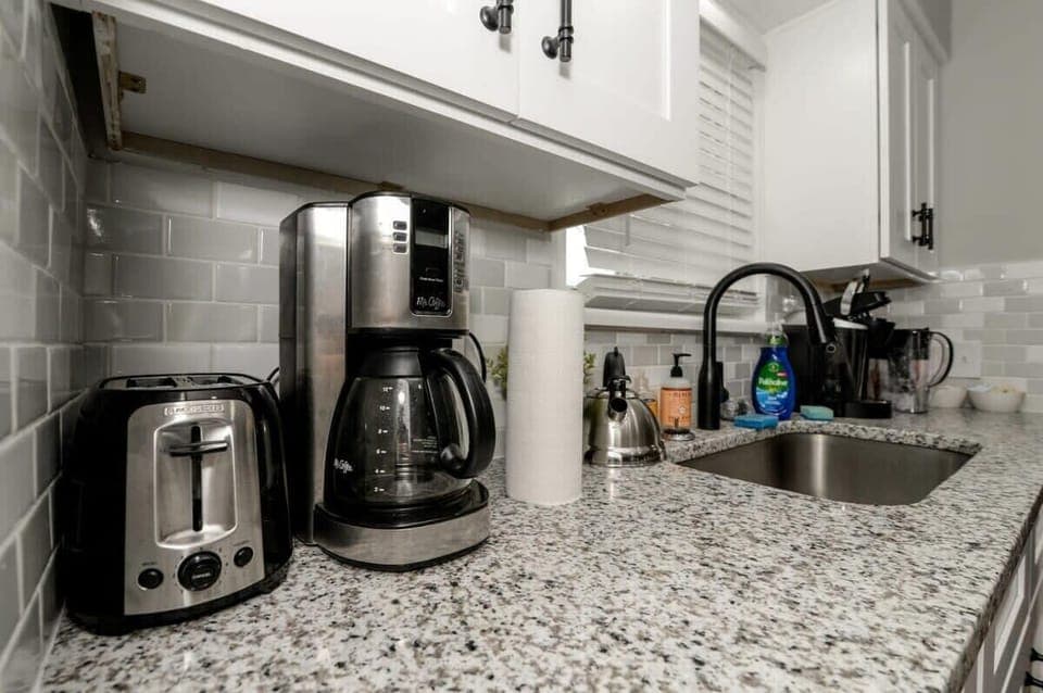 Countertop with Coffee Maker and Toaster
Start your day right with a fully equipped countertop featuring a coffee maker and toaster. Whether it’s a morning brew or a quick breakfast, everything you need is right at your fingertips.