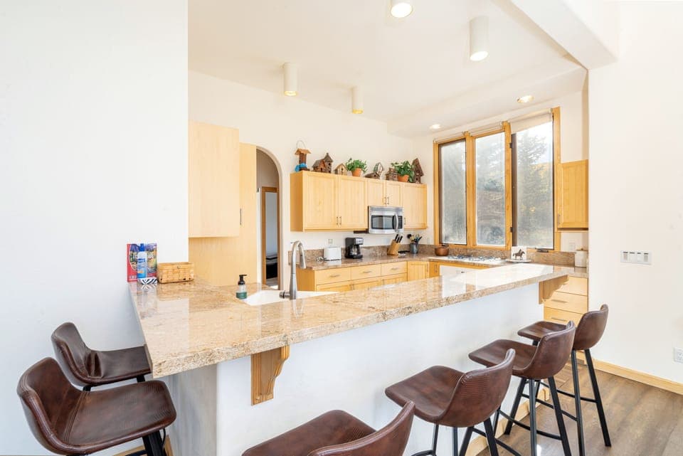 Open kitchen with breakfast bar seating for six