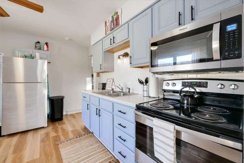 - Fully equipped kitchen with stainless appliances   - Blue cabinets with modern finishes and storage   - Cook meals with ease during your stay  