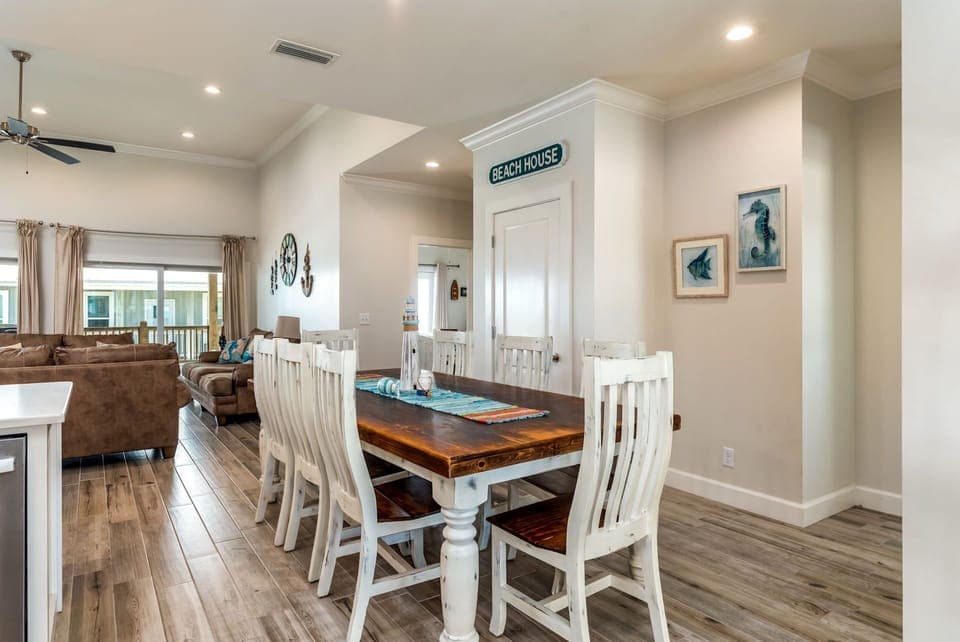 Gather around this charming coastal dining table where your group can share meals and create memories in this bright, beach-themed space.