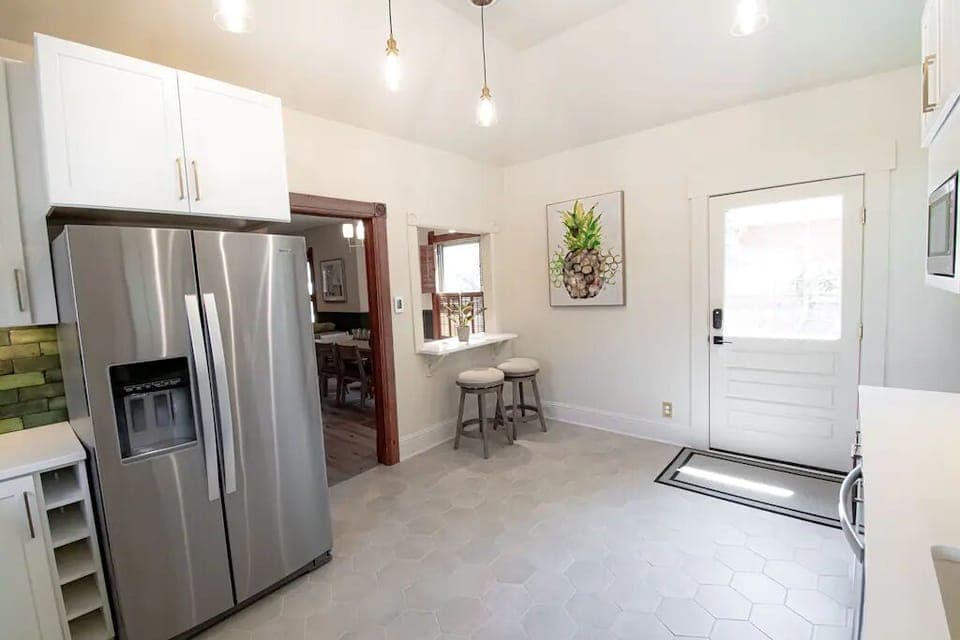 The eat-in bar opens seamlessly to the living and dining spaces, with easy access to the porch and backyard—perfect for indoor-outdoor flow. 🍷🌿