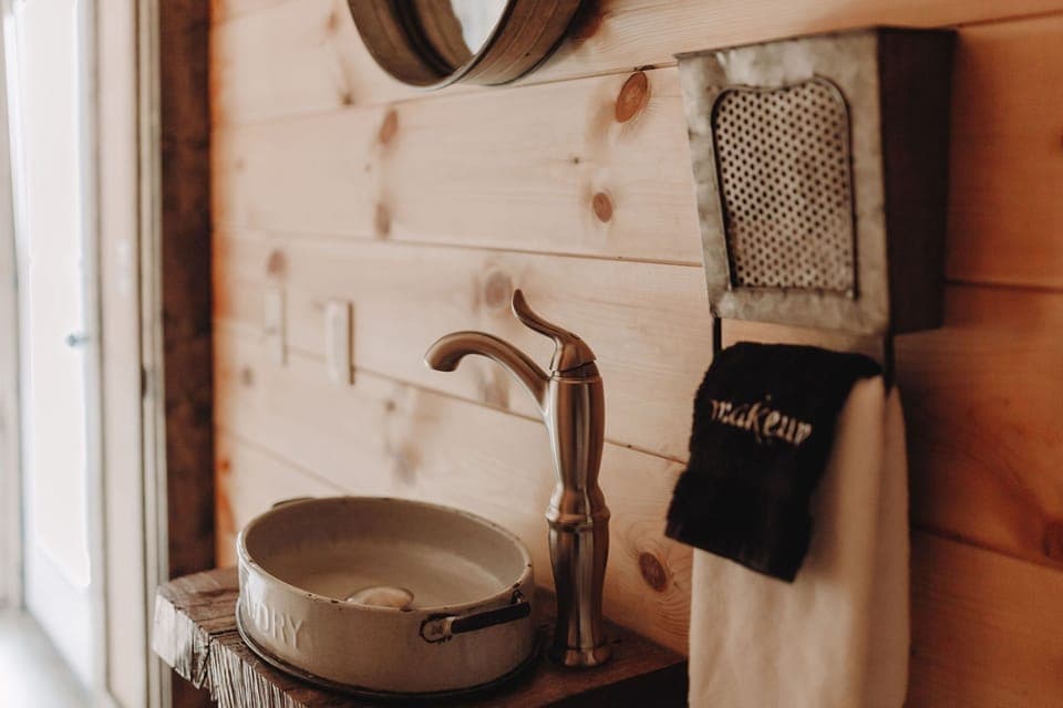 The powder bath is nestled under the stairs, convenient for guest use.