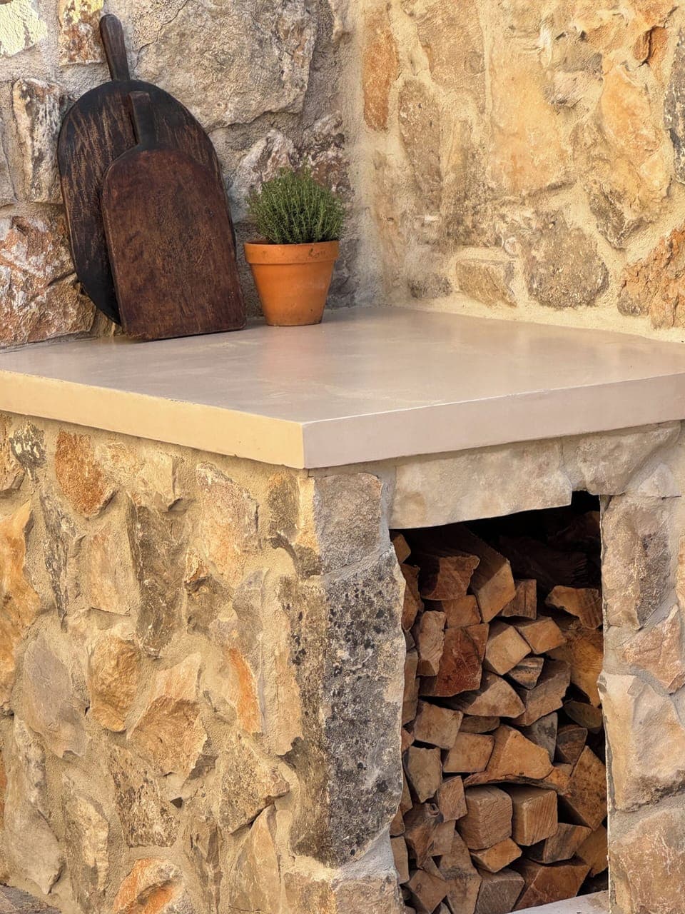 Wood-burning pizza oven stocked with wood