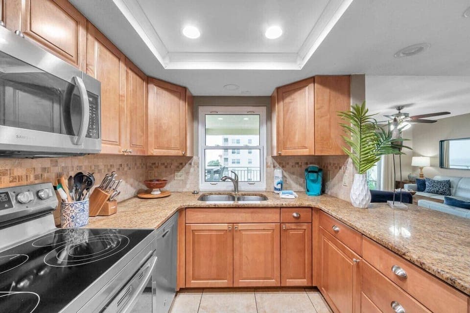 Bright kitchen w/ stainless appliances, granite counters, and a clean, functional layout