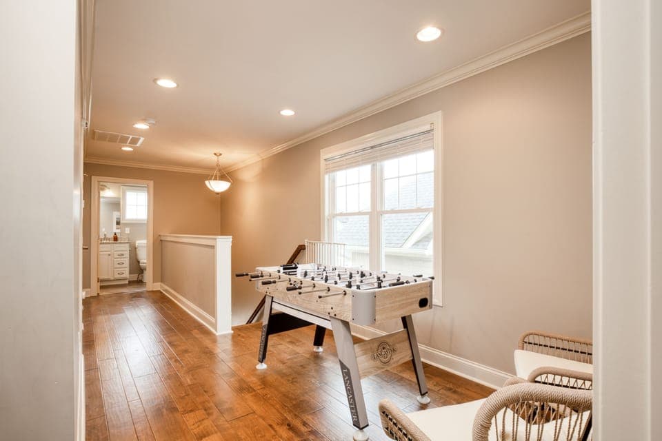 Foosball table and small lounge area at the top of the stairs.