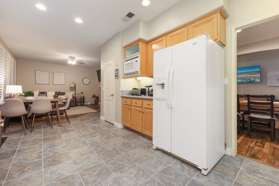 A small dining table is attached to the kitchen. Living room is also within sight. Great room!