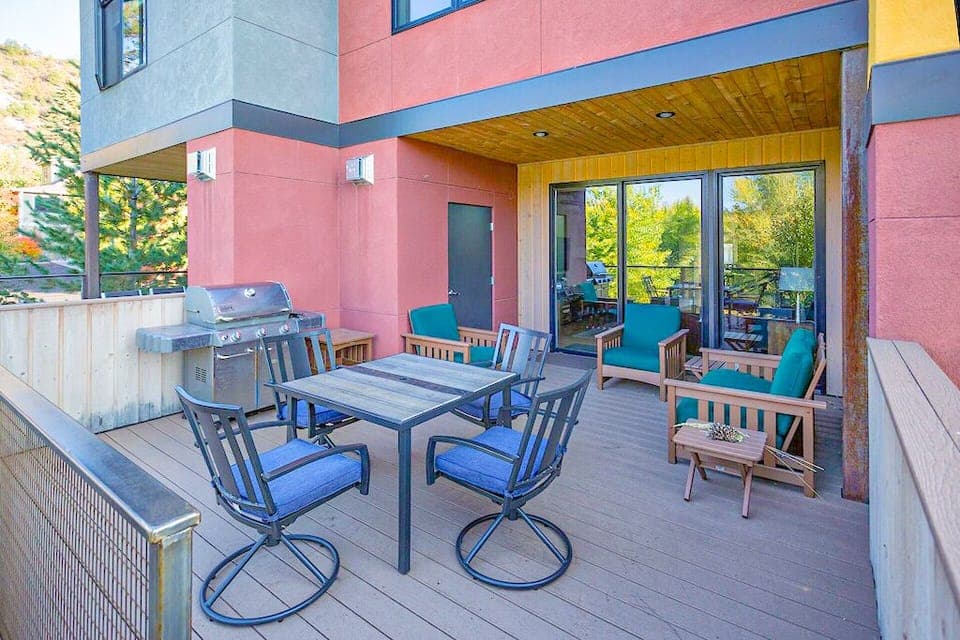 Main floor deck with BBQ and table for outdoor dining.