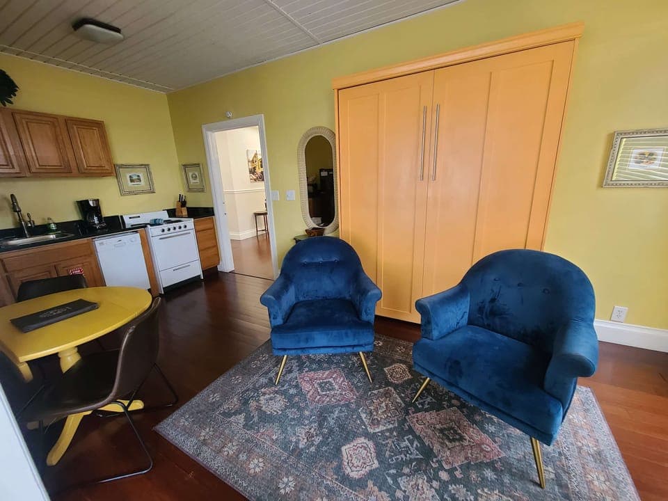queen murphy bed, seating area and dining table or workstation