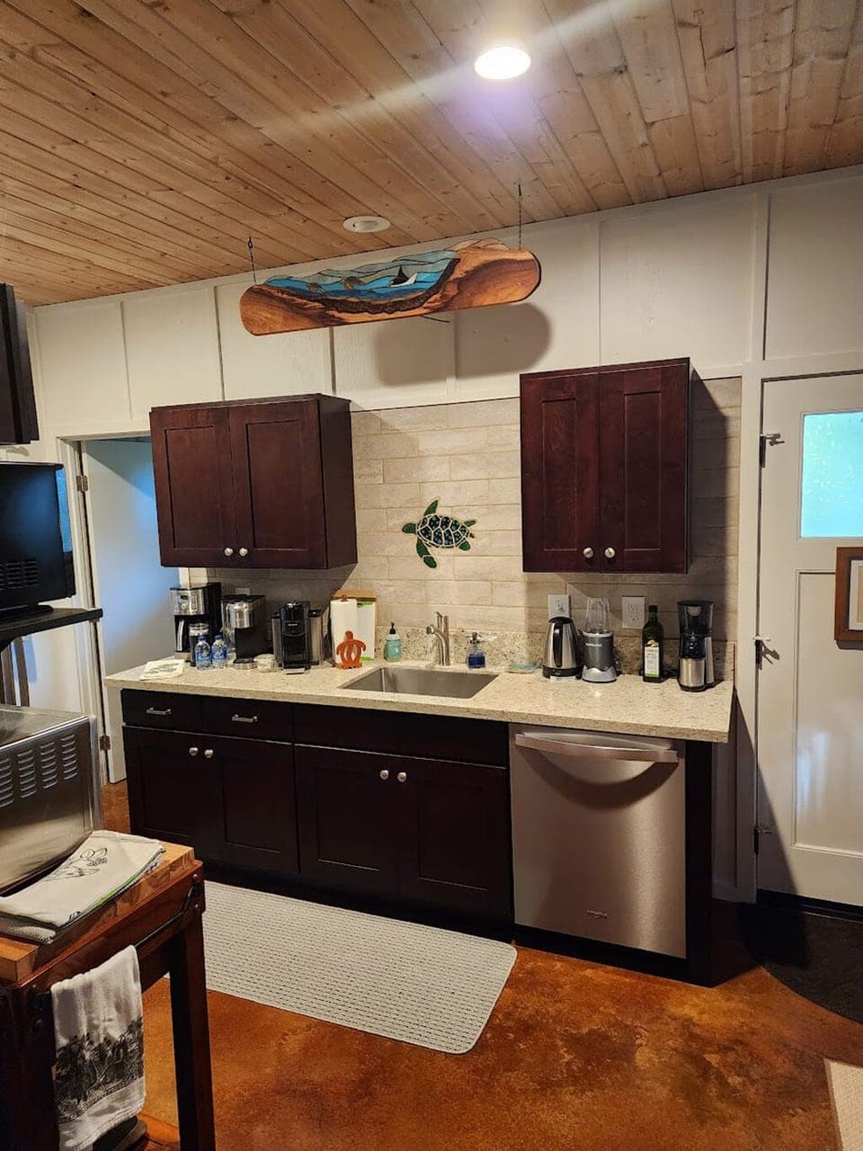 Fully stocked with plates, bowls, cups, silverware, cooking utensils, dishwasher