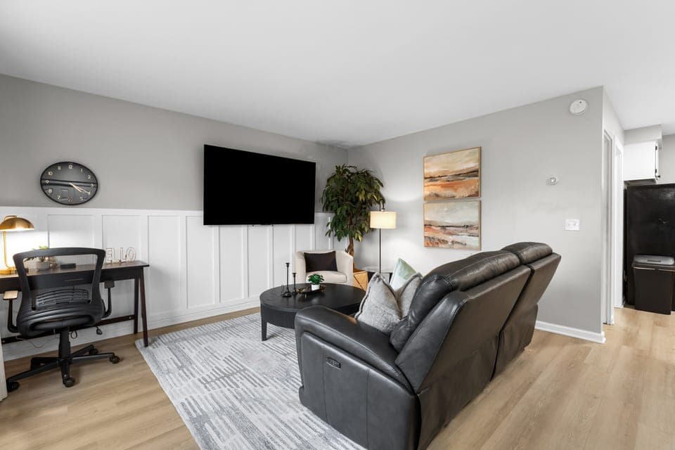 Enjoy your favorite shows on our 75in Smart TV and Double Recliner Sofa