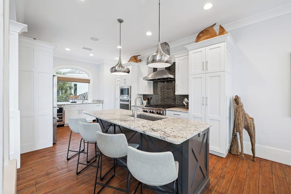Create culinary masterpieces in this elegant kitchen with granite countertops, professional-grade appliances, and spacious island seating for memorable meals.