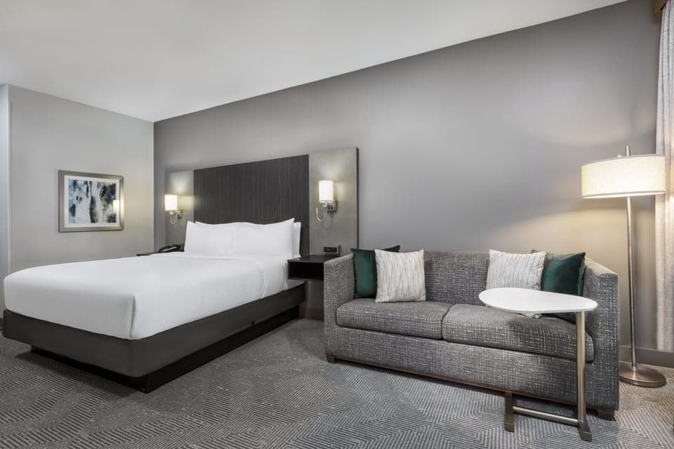 Premium bedding, desk, laptop workspace, iron/ironing board