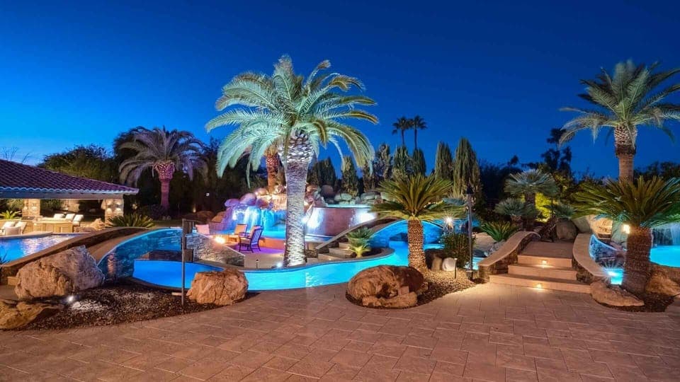 Breathtaking pool w/ lazy river, spa, & waterfalls surrounded by palm trees