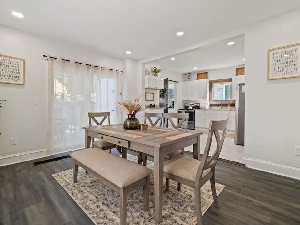 Bright dining area with seating for six plus a bench   - Open flow to kitchen with modern appliances and décor   - Perfect for shared meals and gathering together