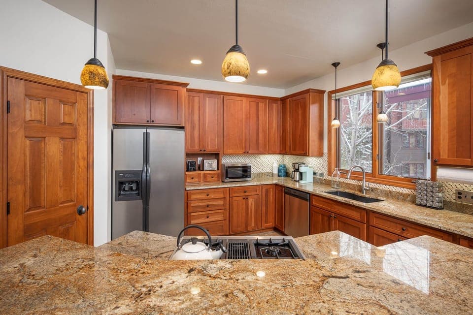 The kitchen is fully stocked with updated appliances
