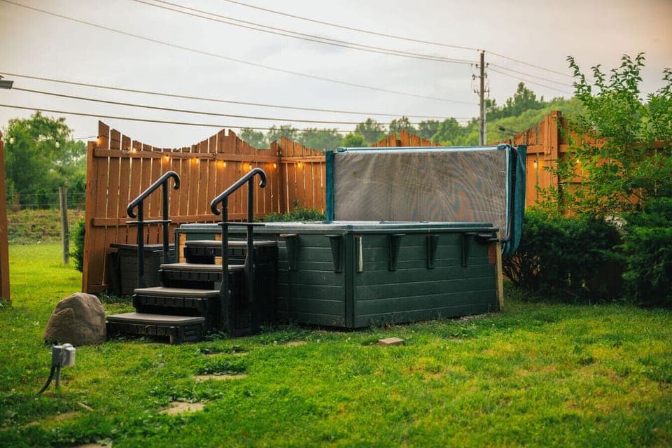 Your own private soak spot- unwind in the hot tub under the string lights with peaceful views all around!
