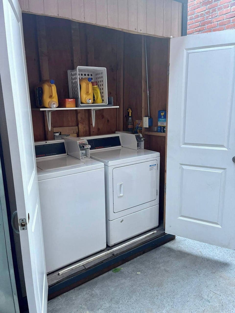 There is a building coin-op WASHER and DRYER located in the rear courtyard.  Detergent is provided and you can get change from the convenience store out front
