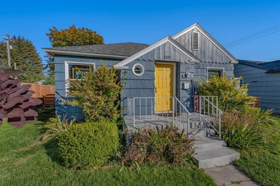 The bright yellow door & quaint patio greet you upon arrival