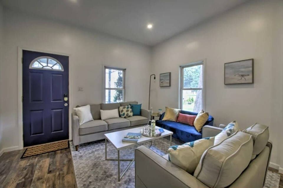 The living room warmly welcomes you with cozy seating and a charming ambiance, perfect for relaxation and enjoyment.