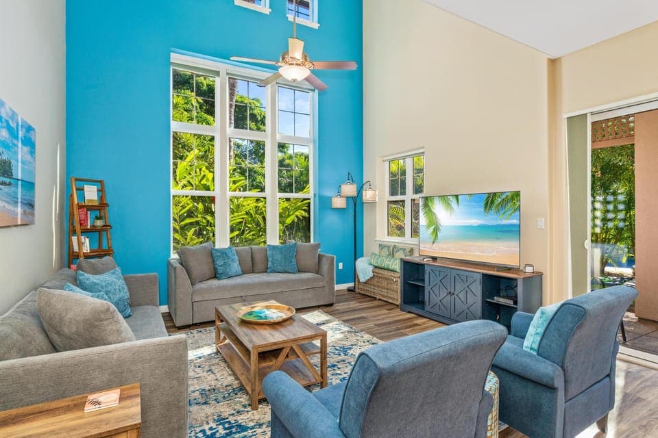 Spacious, bright living room with vaulted ceilings and tall windows