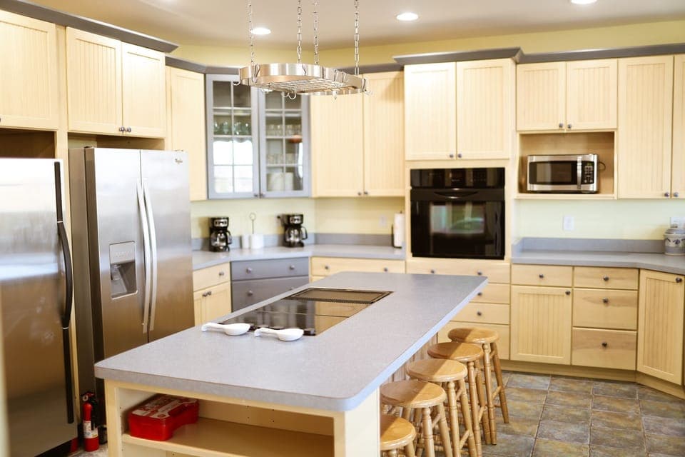 The center island of the kitchen provides additional dining space for guests. 